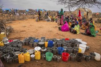 Women and children wait for water in Ethiopia during drought.