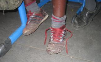 dem Attending school helps children from poor families escape poverty: footwear seen in a Nairobi classroom.