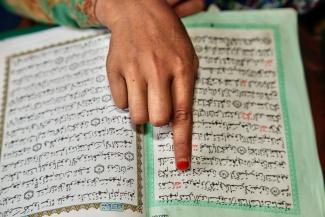 Muslim girl reading from the Quran at a Madrassa.