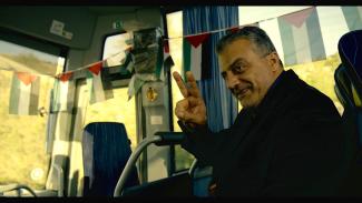 The manager of the Palestinian team, played by Norman Issa.