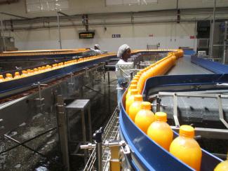 Gainful employment: worker at a juice producing facility owned by the Kenyan brand Kevian near Nairobi.