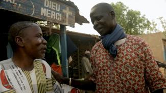 Pastor Tankpari Guitanga (left) with a mentally ill person under his care.