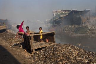 A clean environment is a public good: children playing in a neighbourhood polluted by emissions from the leather industry in Dhaka, Bangladesh.