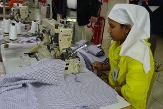 Workers in the formal sector often enjoy health insurance and pension plans: a seamstress in Bangladesh.