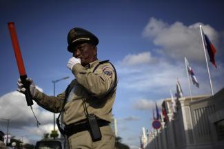 Police officer regulating traffic in Phnom Penh: the government is preparing new rules to define how state and citizens interact