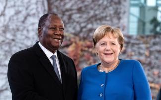 German Chancellor Angela Merkel welcoming President Alassane Ouattara to the Compact with Africa conference in Berlin in 2019.