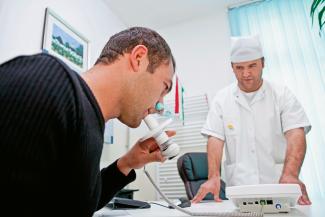 Examining the lungs of a patient in Tajikistan.