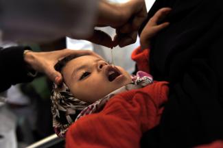 Immunising a child in Sanaa, Yemen.