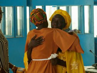 A victim embracing her lawyer after a TRRC hearing.