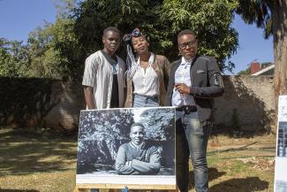 GALZ activists with a photo of one of themselves in Harare, Zimbabwe.