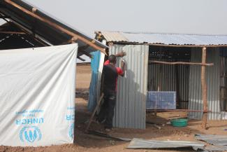 A man building what will probably become a family’s permanent residence.