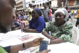 Voter registration with digital card readers in Lagos before the 2015 elections.