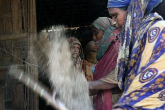 Workers at a rice mill in Bangladesh: breathing in the dust often causes lung disease.
