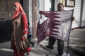 Street protest in Cairo: a man tears up a Qatari flag in April 2013 because of that country’s support for the Muslim Brothers.