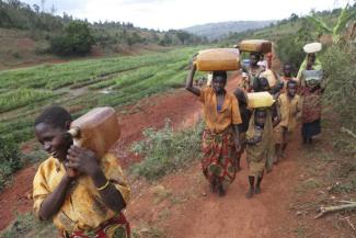 Extreme poor people like here in Burundi often have to walk many kilometres to fetch drinking water. This is work for women and children.