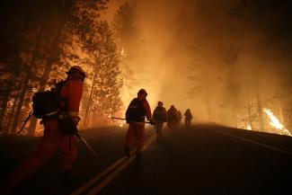 Climate-change induced dryness is making forest fires in North America more frequent and devastating: firemen on the edge of Yosemite National Park in late August.