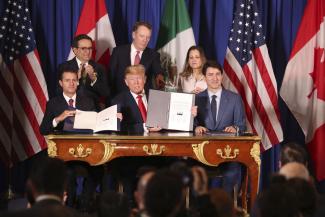 Not much is new, apart from the name: Enrique Peña Nieto, Donald Trump and Justin Trudeau celebrate the signing of the United States-Mexico-Canada agreement in November 2018.