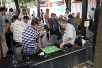 Singapore’s government wants senior citizens’  to be secure: pensioners playing board games.