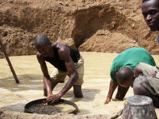 Those working for  a pittance in the extractive sector are excluded from social services: washing diamonds in Sierra Leone.