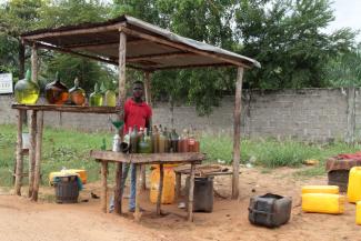 Selling smuggled petrol on the roadside.