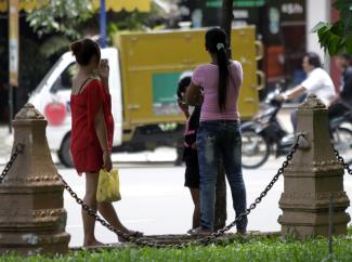 Cambodian sex workers wait for customers at  a public park  in Phnom Penh.