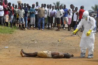 Disinfecting a person in Liberia for training purposes.