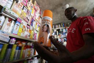 Salesperson with skin-lightening product in Abidjan, Côte d’Ivoire, in 2016.