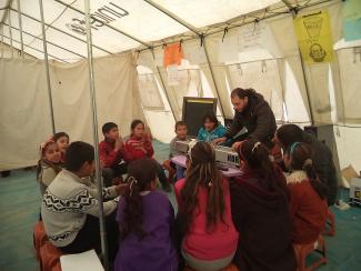 Music class in a school run on behalf of UNICEF in a refugee camp.