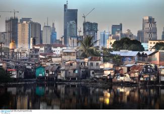 Inequality has been growing almost everywhere: slum huts and highrise buildings in Manila in 2009.