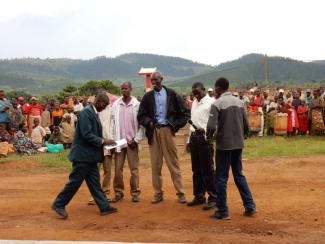 Conflict parties at a ceremony celebrating a settlement.