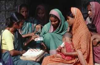 Community health worker promoting condom use in a village in 1995.