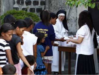 Social justice matters: nuns handing out free meals to poor families in Bulacan.