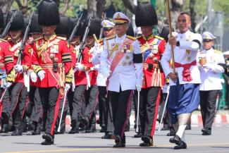 Thailand’s King Maha Vajiralongkorn (center) and honour guard march at a ceremony for late King Bhumibol Adulyadej in October 2017.