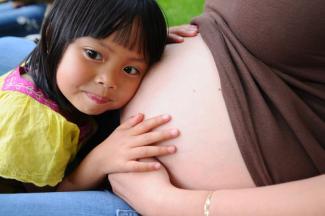 Girl with pregnant woman.