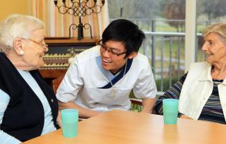 picture-alliance/Sueddeutsche Zeitung Photo/Simon, Johannes A young man from Vietnam is trained to become a staff member in a retirement home near Munich in 2014.