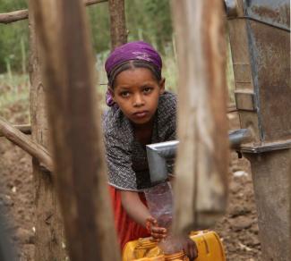 Girl at a well in Ethiopia.
