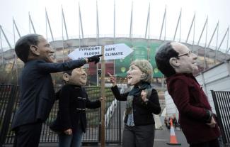 Zborowski/picture-alliance/dpa Oxfam activists at UN climate summit in Warsaw in 2013.