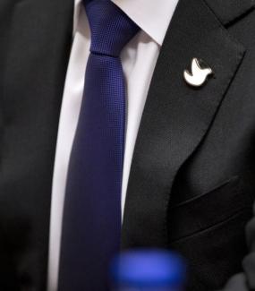 Juan Manuel Santos, Nobel Peace Laureate and Colombian president, wears a dove on his lapel.
