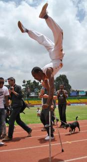 World record: Tameru Zegeye managed to run 100 metres in 56 seconds on his arms and crutches.