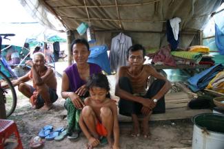 Illness has made the breadwinner (right) in this Cambodian family unfit for work.
