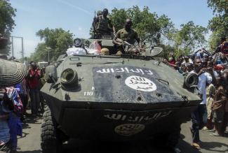 Soldiers parading an armored vehicle seized from Boko Haram in Maiduguri.