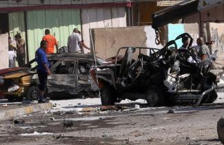 Violence may flare up any time: wreck of car bomb in Baghdad in late September 2013.