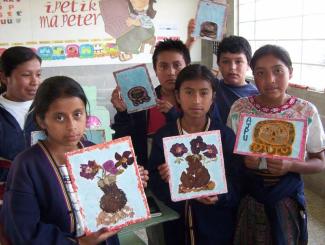 To ensure inclusive primary education, bilingual and intercultural instruction is needed: indigenous pupils show handcrafted pictures of Maya symbols.