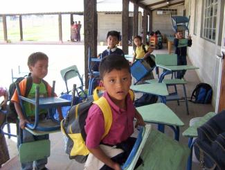 Nicht jede Schule auf dem Land ist so gut ausgestattet: indigene Grundschüler mit Schreibpulten in Guatemala.