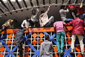 Eager to leave: when Saudi Arabia announced 10,000 workers would be recruited last, young men climbed over the fence of Dhaka’s Expatriate Welfare and Overseas Employment Ministry to register.